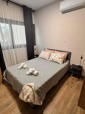 a bedroom with a bed with towels on it at Maroulla's Urban Beach Living in Limassol