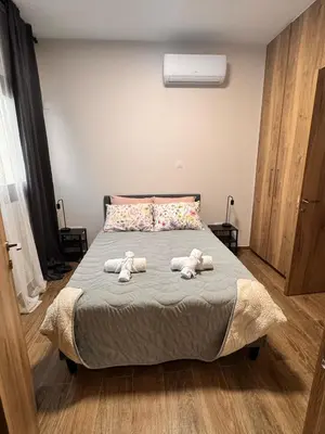 three stuffed animals sitting on a bed in a bedroom at Maroulla's Urban Beach Living in Limassol