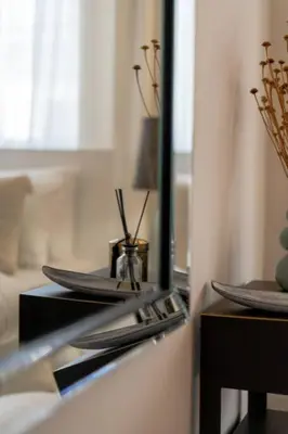 a counter with a mirror and some plates on it at Stylish & Picturesque Oasis Anthorina 2 in Protaras