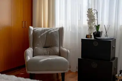 a chair and a dresser in a room with a window at Stylish & Picturesque Oasis Anthorina 2 in Protaras