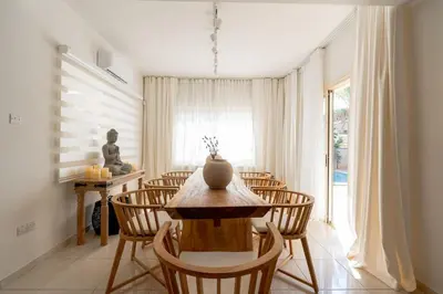 a dining room with a table and chairs at Stylish & Picturesque Oasis Anthorina 2 in Protaras