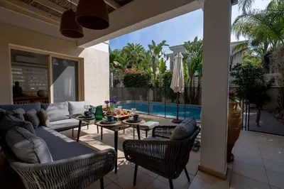 a patio with a couch and a table and chairs at Stylish & Picturesque Oasis Anthorina 2 in Protaras