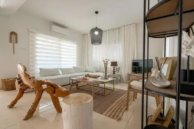 a living room with a couch and a table at Stylish & Picturesque Oasis Anthorina 2 in Protaras