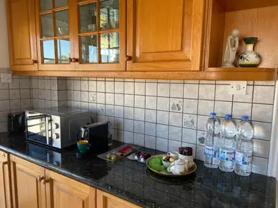 a kitchen counter with a plate of food and water bottles at Sunny 2 bedroom flat in Engomi in Engomi