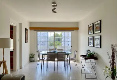 a dining room with a table and chairs and a window at Sunny 2 bedroom flat in Engomi in Engomi