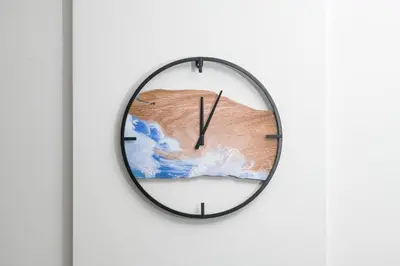a black and white clock hanging on a wall at Olympia Flat 104 in Larnaka