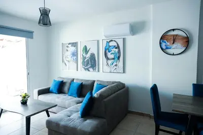 a living room with a couch and a table at Olympia Flat 104 in Larnaka
