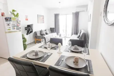 a kitchen and living room with a table and chairs at SPECIAL OFFER -70 Percent Off - 2 BR - Sleep 7 - Best Location at Ayia Napa City Center in Ayia Napa