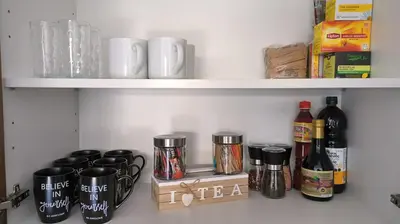 a shelf with bottles and cups on it at SPECIAL OFFER -70 Percent OFF - Sleep 5 - Best Location - Free Parking in Ayia Napa