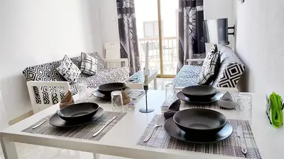 a dining room table with black dishes on top of it at SPECIAL OFFER -70 Percent OFF - Sleep 5 - Best Location - Free Parking in Ayia Napa