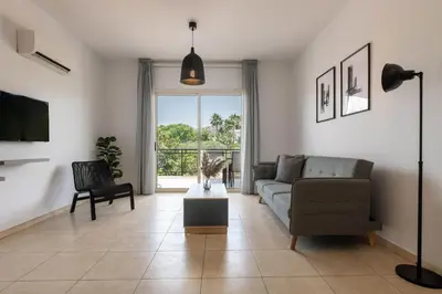 a living room with a couch and a chair at Phaedrus Living Limassol Pyrgos Seaside Flat in Limassol