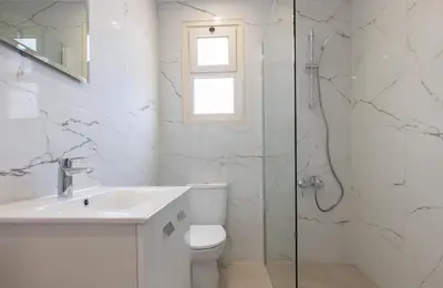 a bathroom with a toilet and a sink and a shower at Phaedrus Living Limassol Pyrgos Seaside Flat in Limassol