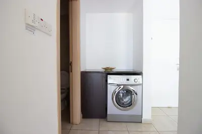 a laundry room with a washing machine in a room at Prime Protaras Seafront Apt in Protaras