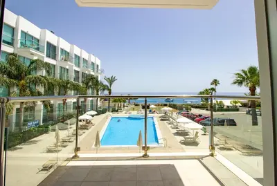 a view of a swimming pool from the balcony of a hotel at Prime Protaras Seafront Apt in Protaras