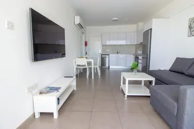 a living room with a couch and a table at Stunning Sea-Views Apt, Protaras in Protaras