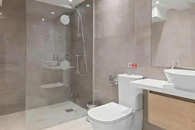 a bathroom with a shower and a toilet and a sink at Serenity Waves Villa 6 in Sophtadhes