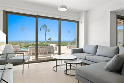 a living room with a couch and a table at Serenity Waves Villa 6 in Sophtadhes
