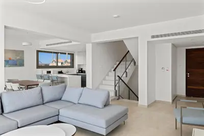 a living room with a couch and a dining room at Serenity Waves Villa 6 in Sophtadhes
