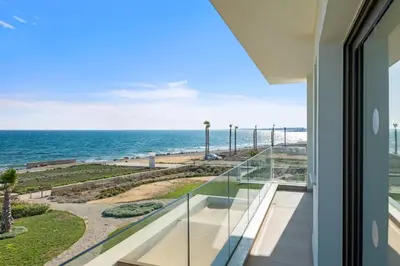 a balcony with a view of the ocean at Serenity Waves Villa 1 in Sophtadhes