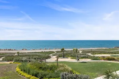 a garden with the ocean in the background at Serenity Waves Villa 1 in Sophtadhes