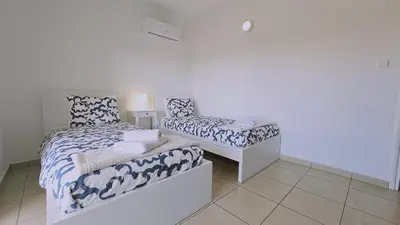a bedroom with a bed and a chair at STAY Skyline Nest in Larnaka