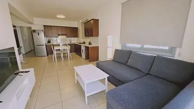 a living room with a couch and a table at STAY Skyline Nest in Larnaka
