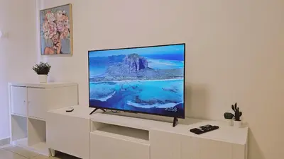 a flat screen tv sitting on top of a white cabinet at STAY Skyline Nest in Larnaka