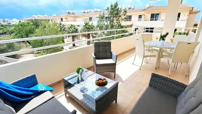 a balcony with a table and chairs on a building at NISSI BEACH Apt 2 RESORT AND SEA VIEW FREE WIFI in Ayia Napa