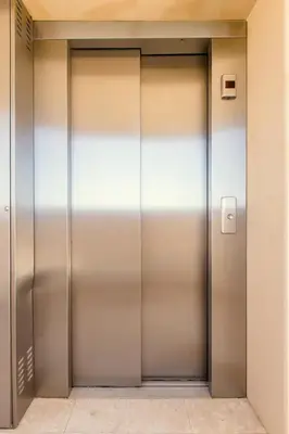 two metal elevator doors in a building at NISSI BEACH Apt 2 RESORT AND SEA VIEW FREE WIFI in Ayia Napa