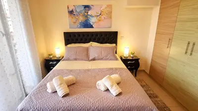 a bedroom with a bed with two towels on it at NISSI BEACH Apt 2 RESORT AND SEA VIEW FREE WIFI in Ayia Napa