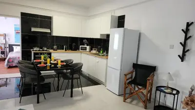 a kitchen with a table with chairs and a refrigerator at Luxurious Orestis in Limassol