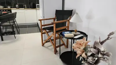 a living room with a chair and a table at Luxurious Orestis in Limassol