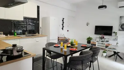 a kitchen and dining room with a table and chairs at Luxurious Orestis in Limassol
