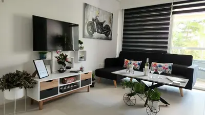 a living room with a tv and a couch and a table at Luxurious Orestis in Limassol