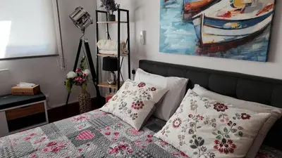 a bedroom with a bed with pillows and a painting at Luxurious Orestis in Limassol