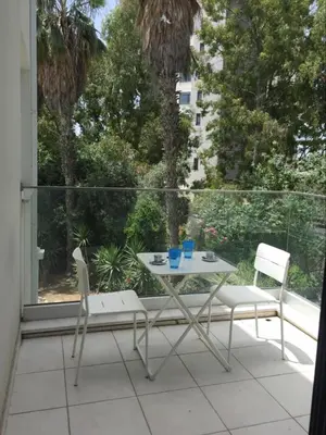 a table and two chairs sitting on a balcony at Modern 1 bedroom sea view beach apartment in Limassol