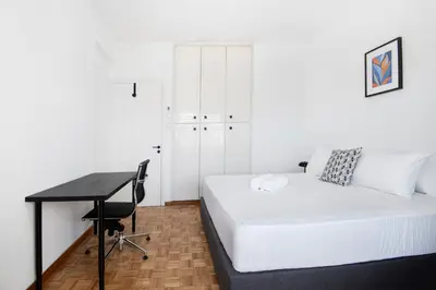 a bedroom with a bed and a desk and a desk at Urban Condo 11 - 1 Bdr in Nicosia