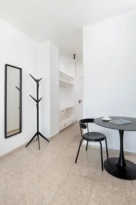 a table and chairs in a room with a mirror at Urban Condo 11 - 1 Bdr in Nicosia