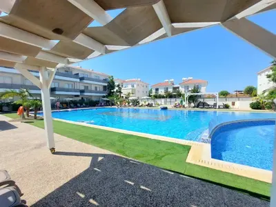 a swimming pool under an umbrella in a resort at Mythical Sands - Aura in Paralimni