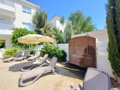 a row of chairs and umbrellas on a patio at Mythical Sands - Aura in Paralimni