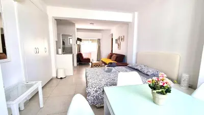 a small living room with a couch and a table at Stylish Studio - 2 Minutes from Kastella Beach in Larnaka