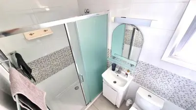 a bathroom with a shower and a sink and a mirror at Stylish Studio - 2 Minutes from Kastella Beach in Larnaka