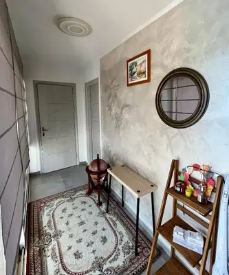 a hallway with a table and a mirror on a wall at A Detached Floor in Parekklisha