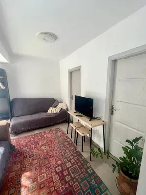 a living room with a couch and a desk with a computer at A Detached Floor in Parekklisha