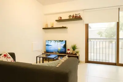 a living room with a couch and a television at Old town studio in Limassol