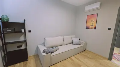 a living room with a couch and a shelf at STAY Lima Soul Apartment in Limassol