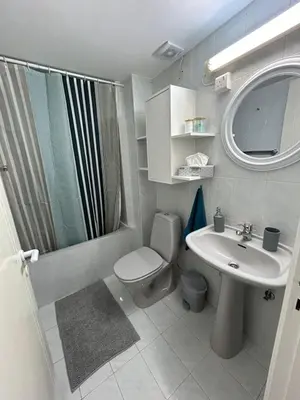 a bathroom with a toilet and a sink and a shower at Nikoletta apartman in Limassol