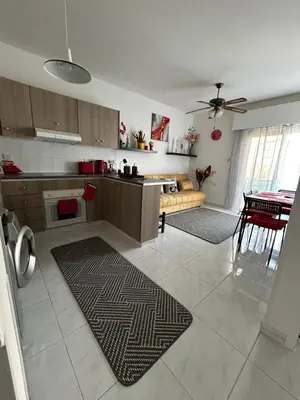a kitchen with a couch and a table in a room at Nikoletta apartman in Limassol