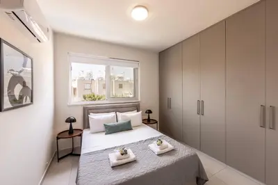a bedroom with a bed with two towels at Protaras Mythical Seas in Protaras