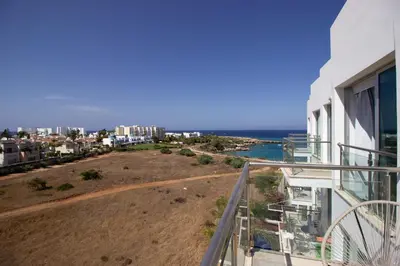 a balcony of a house with a view of the ocean at Seafront Stylish Apt, Protaras in Protaras